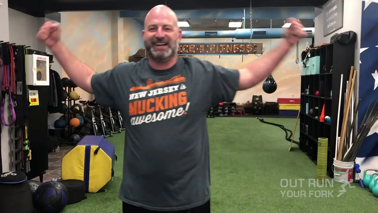 A happy Out Run Your Fork client celebrating mid-workout in the studio
